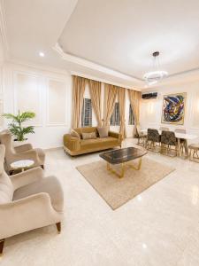 a large living room with couches and a table at Nathivian Apartment in Mobushipe