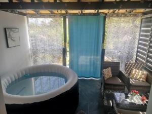 a bath tub in a room with a window at Apt Amor in Bihać +2 photos