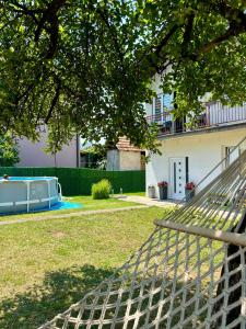 a hammock in the yard of a house at APARTMAN BAMBUS in Lug
