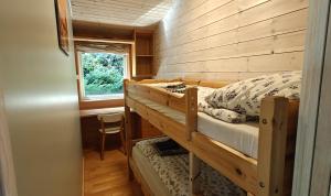 a bedroom with two bunk beds in a cabin at Villa Verde by Hvalstrand beach in Nes