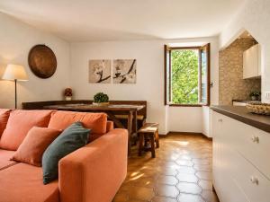 a living room with a couch and a table at Casa Bucaneve & Ciclamino in Gravedona