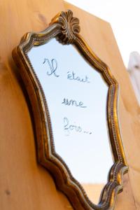 a framed mirror on a table with the words last dance forever at La cabane féerique in Ames
