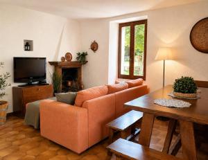 a living room with a couch and a table at Casa Bucaneve & Ciclamino in Gravedona