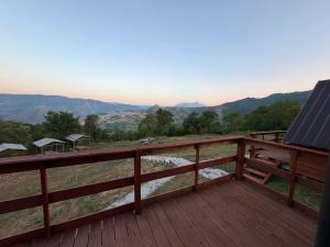 a deck with a view of the mountains at Strofka in Maliq +25 photos