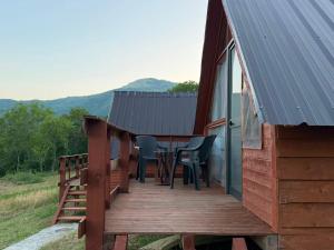 a wooden deck on the side of a cabin at Strofka in Maliq