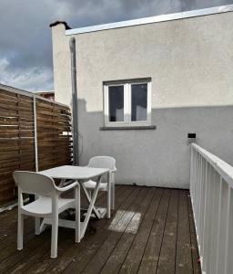 a patio with a table and chairs on a deck at Yamohome in Brussels