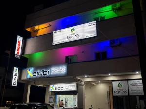 a store with colorful signs on the side of a building at Hotel Far-Inn in Irungattukottai