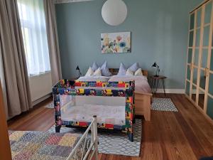 a bedroom with a bed with a crib in it at Ferienwohnung Zölkow in Kladrum +10 photos