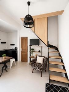 a living room with a staircase and a zebra print chair at Studios Riviera in Bandol +12 photos