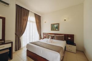a bedroom with a bed and a large window at Fantasia Hotel in Hurghada +46 photos