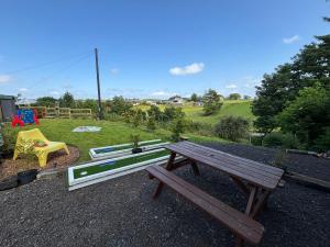 a picnic bench and a playground in a park at Pentland View Campsite in Haywood