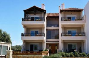 a large white building with balconies on it at Kyma&Soul Seaview Loft in Xylokastro