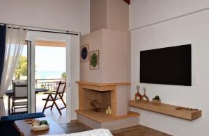 a living room with a fireplace and a flat screen tv at Kyma&Soul Seaview Loft in Xylokastro
