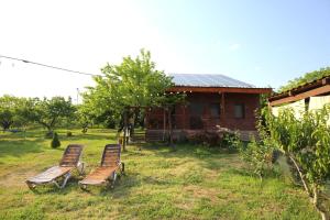 two chairs sitting in the grass in front of a house at Noravank L-and-L in Aghavnadzor