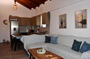 a living room with a couch and a table at Kyma&Soul Seaview Loft in Xylokastro