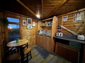 a kitchen with a table and a small table in a cabin at Pentland View Campsite in Haywood