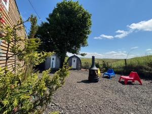 a yard with a bottle of wine and some chairs at Pentland View Campsite in Haywood