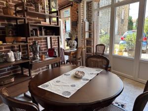 a dining room with a wooden table and chairs at Grange d'époque à Chantilly in Chantilly +13 photos