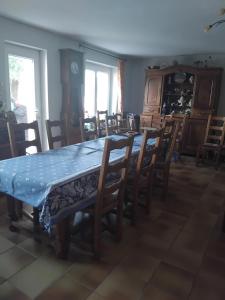 a dining room with a table and chairs at Chez Danielle in Saint-Georges-de-Baroille
