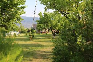 a park with trees and a swing at Noravank L-and-L in Aghavnadzor +19 photos