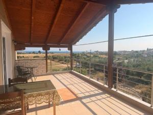 a balcony with a table and chairs and a view at Sonya Apartments in Mesochórion