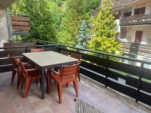 a table and chairs on top of a balcony at FREE PARKING - Edilneve Apartment in Roccaraso