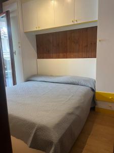 a bedroom with a bed with a wooden headboard at FREE PARKING - Edilneve Apartment in Roccaraso