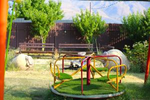 a playground with colorful equipment in a yard at Noravank L-and-L in Aghavnadzor