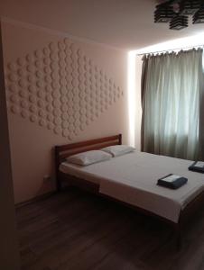 a bedroom with a bed with a large headboard at Potemkin view suites in Odesa