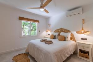 a bedroom with a bed with towels on it at Casa Lou Lou JAVEA in Benitachell +51 photos