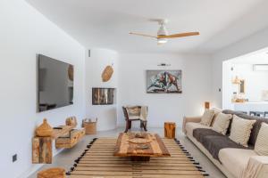 a living room with a couch and a table at Casa Lou Lou JAVEA in Benitachell