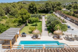 an outdoor swimming pool with a view of a resort at Casa Lou Lou JAVEA in Benitachell