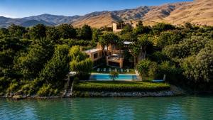 an aerial view of a house in the middle of a river at Villa bord du lac takerkoust marrakech , 9 Suites de Luxe & événementiel in Wawizelt