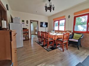 a kitchen and dining room with a table and chairs at Mátra Kulcsosház - Mátraszentimre in Mátraszentimre