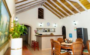 a kitchen and dining room with a table and chairs at casa maria in La Romana