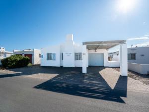 a white building with the sun in the sky at Ivory Pearl in Paternoster