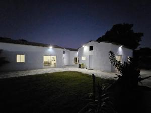 a white house at night with lights on it at CASA Les Deux R da Lagoa in Jijoca de Jericoacoara