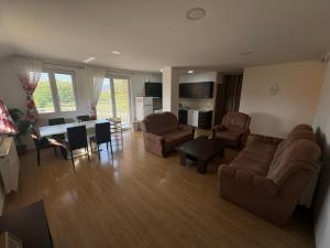 a living room with a couch and chairs and a table at Apartman L&L in Sarajevo