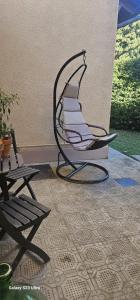 a rocking chair sitting on a patio next to a table at Villa Rosetta in Airasca