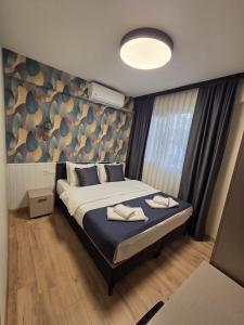 a bedroom with a bed with two towels on it at Zulu Suites in Istanbul