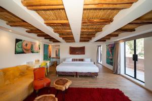 a bedroom with a bed and a couch and a table at Villa bord du lac takerkoust marrakech , 9 Suites de Luxe & événementiel in Wawizelt +36 photos
