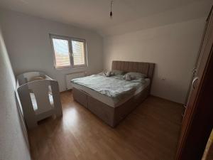 a bedroom with a bed and a mirror in it at Apartman L&L in Sarajevo