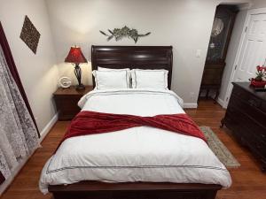 a bedroom with a large bed with a red blanket at National Harbor Suite 3 in Fort Washington