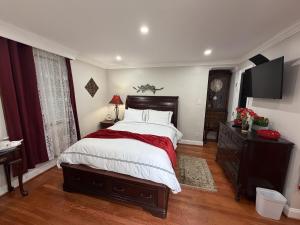 a bedroom with a bed and a dresser and a television at National Harbor Suite 3 in Fort Washington