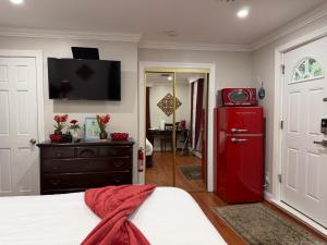 a bedroom with a red refrigerator and a bed at National Harbor Suite 3 in Fort Washington +13 photos