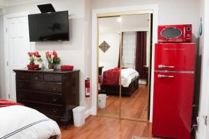 a red refrigerator in a room with a bedroom at National Harbor Suite 3 in Fort Washington