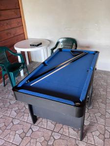 a pool table sitting in a room with a chair at Barbora chata in Nitrianske Rudno