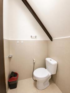 a bathroom with a white toilet in a room at Wave Cafe INN in General Luna