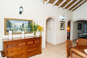 a dining room with a wooden dresser and a table at casa maria in La Romana