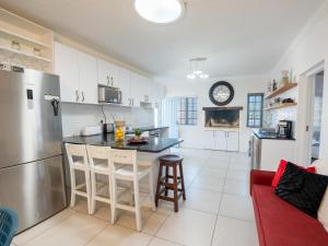 a kitchen with a refrigerator and a counter top at Ivory Pearl in Paternoster